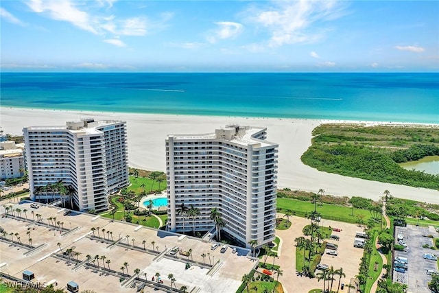 birds eye view of property with a water view and a view of the beach