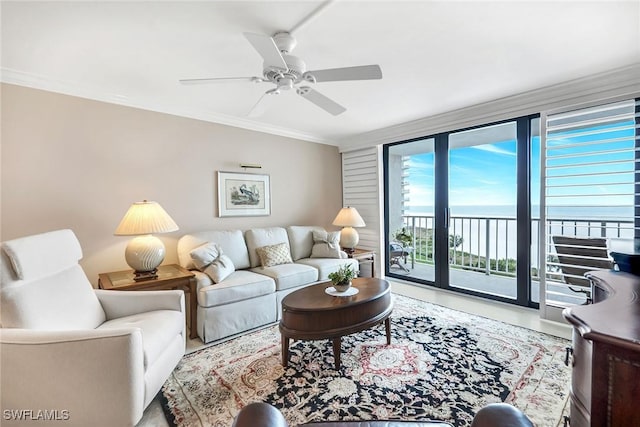 living area featuring ceiling fan and crown molding