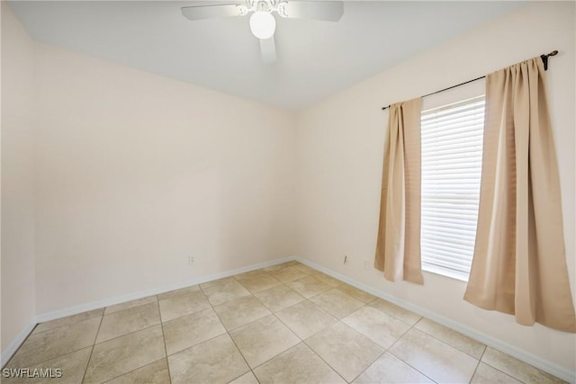 unfurnished room featuring ceiling fan, light tile patterned flooring, and baseboards