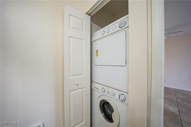 washroom with stacked washing maching and dryer, baseboards, laundry area, and a ceiling fan