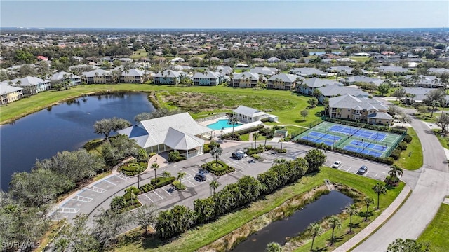 drone / aerial view featuring a water view and a residential view