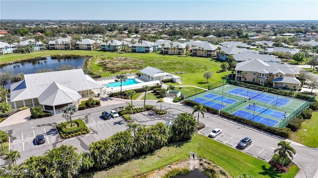 drone / aerial view with a residential view and a water view