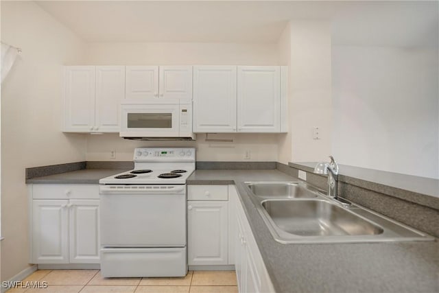 kitchen featuring white appliances, white cabinets, and a sink