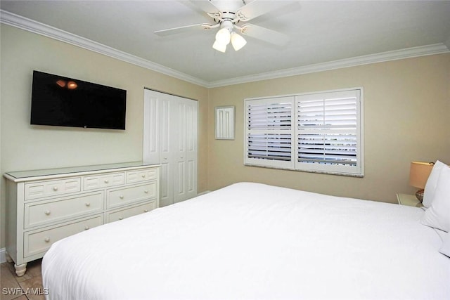 bedroom with a closet, light tile patterned flooring, a ceiling fan, and crown molding