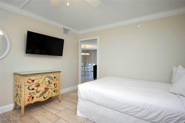 bedroom with baseboards, ceiling fan with notable chandelier, visible vents, and crown molding