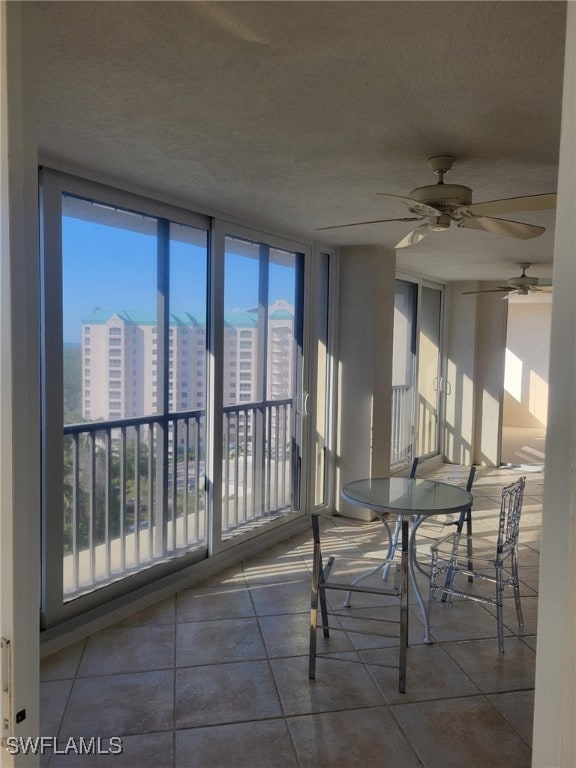 unfurnished sunroom with a wealth of natural light and a view of city