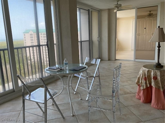 dining area with light tile patterned floors and a ceiling fan