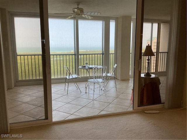 unfurnished sunroom featuring a healthy amount of sunlight and a ceiling fan