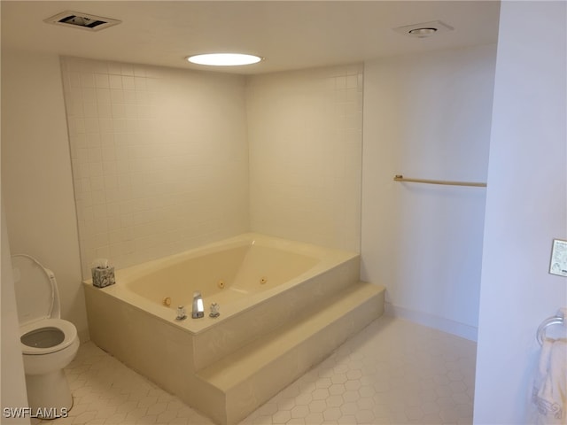 full bathroom featuring visible vents, toilet, tile patterned flooring, baseboards, and a tub with jets