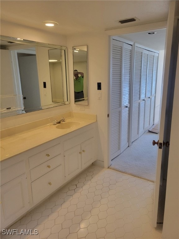 full bathroom with recessed lighting, visible vents, and vanity