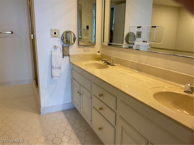 bathroom featuring double vanity, a sink, and tile patterned floors