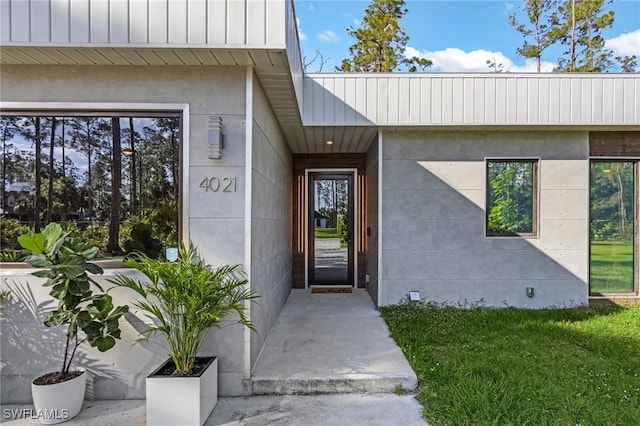 doorway to property featuring stucco siding