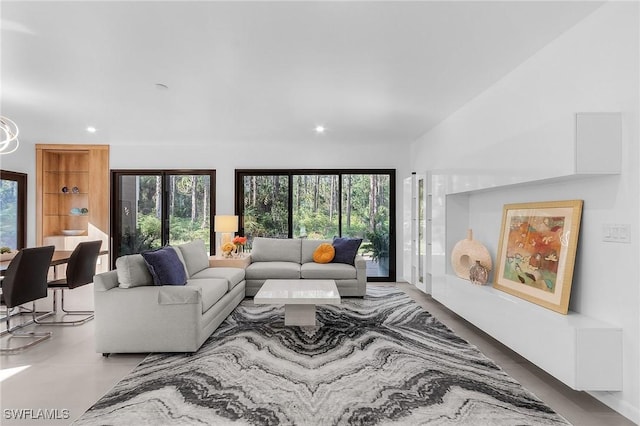 living area with lofted ceiling, a wealth of natural light, and recessed lighting