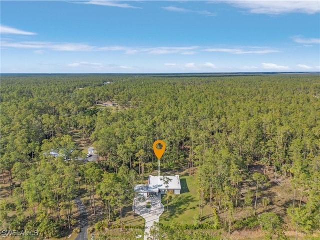 birds eye view of property with a wooded view