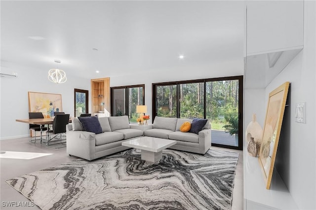 living area featuring a notable chandelier and recessed lighting