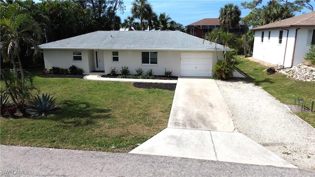 single story home with an attached garage, concrete driveway, a front yard, and stucco siding