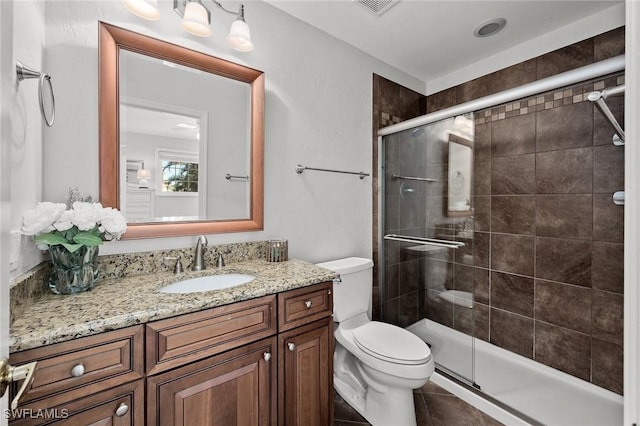 full bath with tile patterned flooring, toilet, visible vents, vanity, and a stall shower