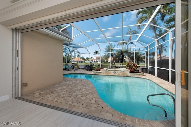 view of swimming pool with glass enclosure, a pool with connected hot tub, and a patio