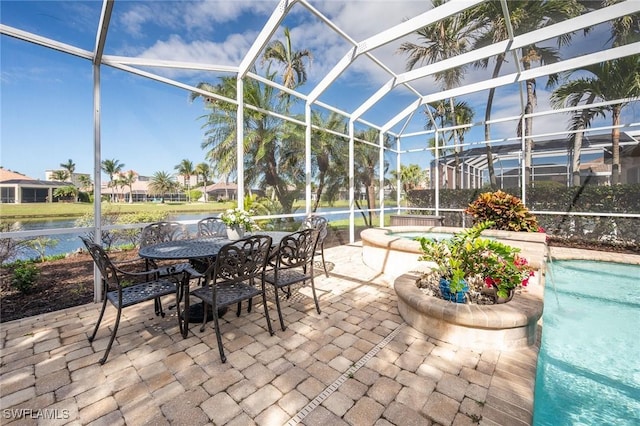 sunroom featuring a water view