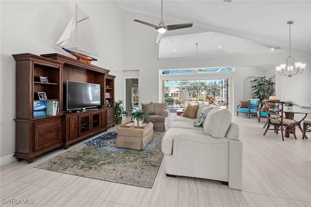 living area with high vaulted ceiling, crown molding, baseboards, and ceiling fan with notable chandelier