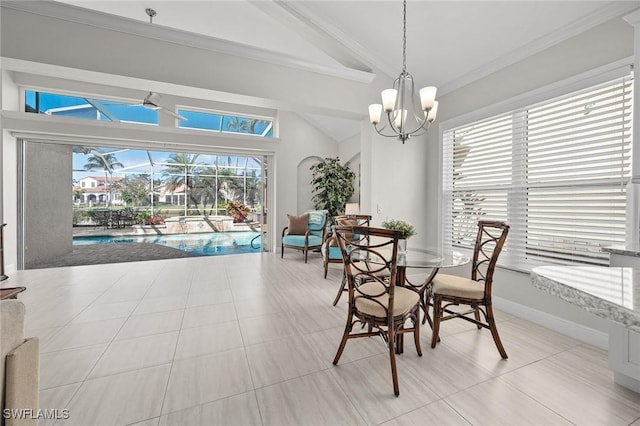 dining area featuring baseboards, lofted ceiling, a sunroom, ornamental molding, and a chandelier