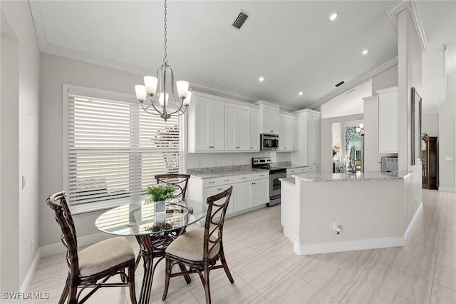 kitchen with white cabinets, a chandelier, stainless steel appliances, and crown molding