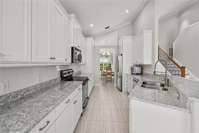 kitchen featuring an inviting chandelier, white cabinetry, appliances with stainless steel finishes, and a sink