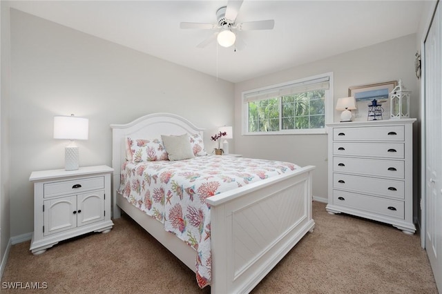 bedroom featuring light carpet and a ceiling fan