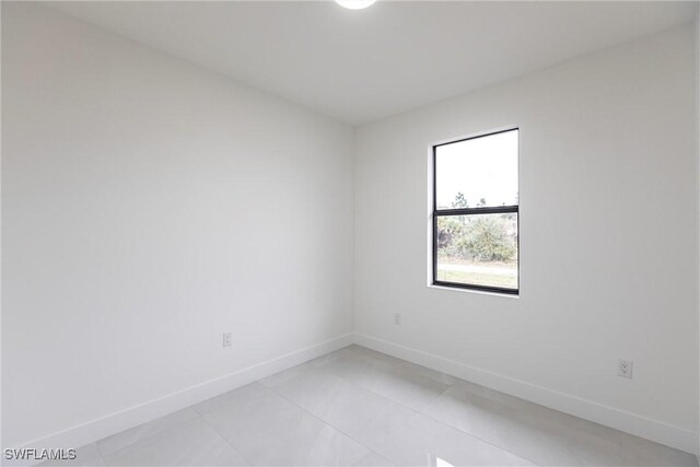 unfurnished room featuring baseboards