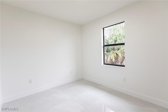 empty room featuring baseboards