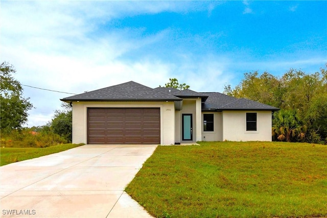 view of front of property with a garage, driveway, roof with shingles, a front lawn, and stucco siding