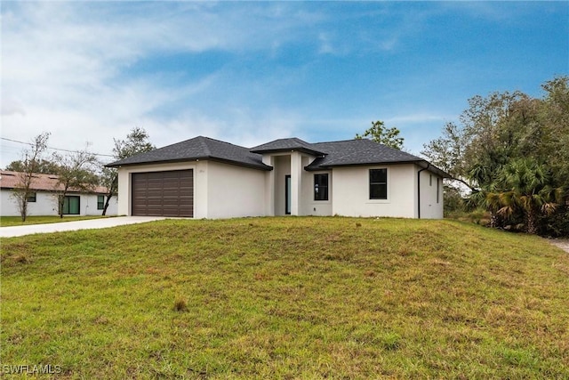 view of front of home with a front lawn, concrete driveway, and an attached garage