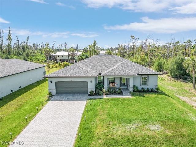 ranch-style home featuring a front yard, decorative driveway, an attached garage, and stucco siding