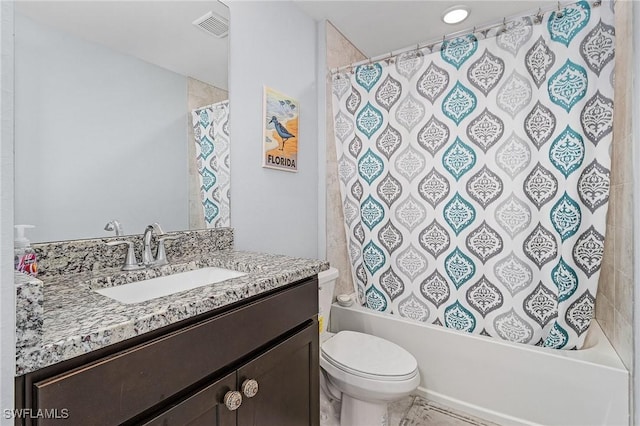 bathroom featuring visible vents, shower / tub combo with curtain, vanity, and toilet