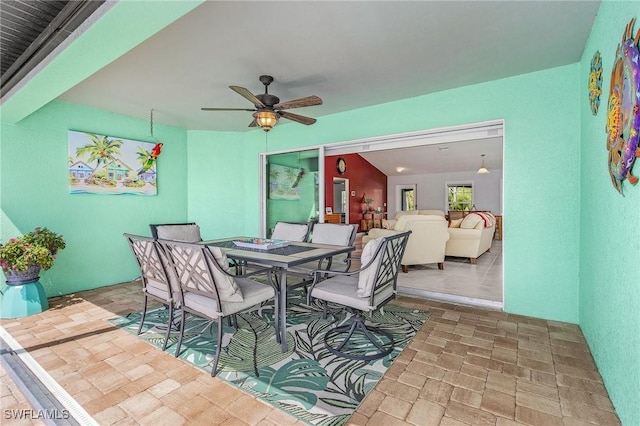 dining room featuring stone finish flooring and ceiling fan