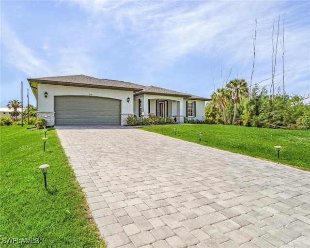 view of front of home with a garage, a front lawn, decorative driveway, and stucco siding