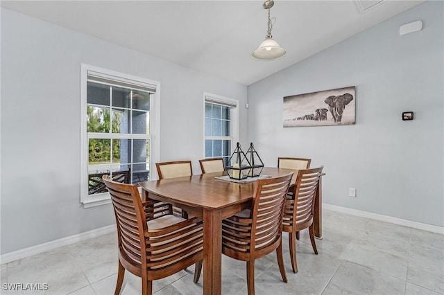 dining area with lofted ceiling and baseboards