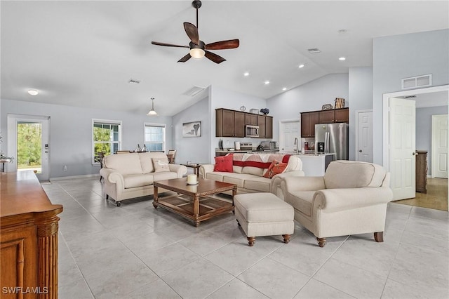 living room featuring light tile patterned floors, high vaulted ceiling, visible vents, and a ceiling fan