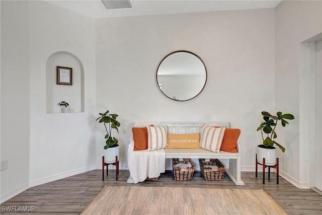 sitting room featuring baseboards, visible vents, and dark wood-type flooring