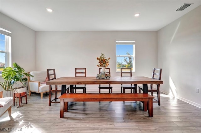 dining space featuring a wealth of natural light, visible vents, recessed lighting, and wood finished floors