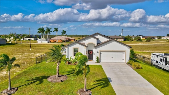 ranch-style home featuring an attached garage, fence, concrete driveway, and stucco siding