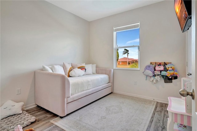 bedroom featuring light wood-style flooring and baseboards