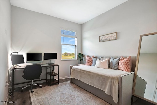 bedroom featuring baseboards and wood finished floors