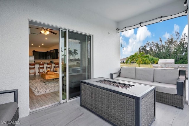 exterior space featuring grilling area and an outdoor living space with a fire pit