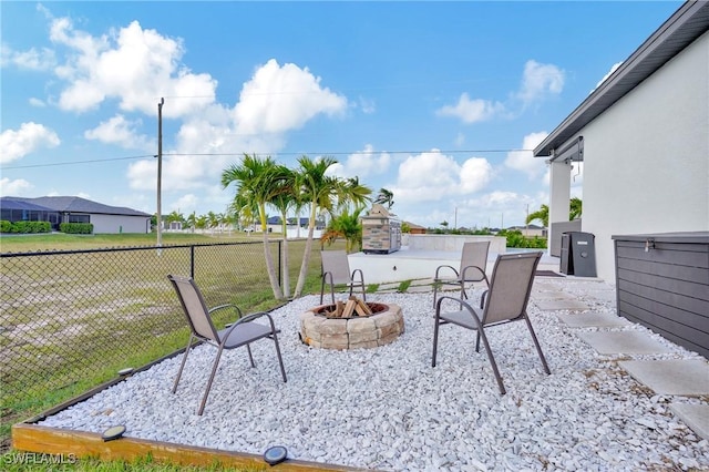 view of patio / terrace featuring an outdoor fire pit and fence