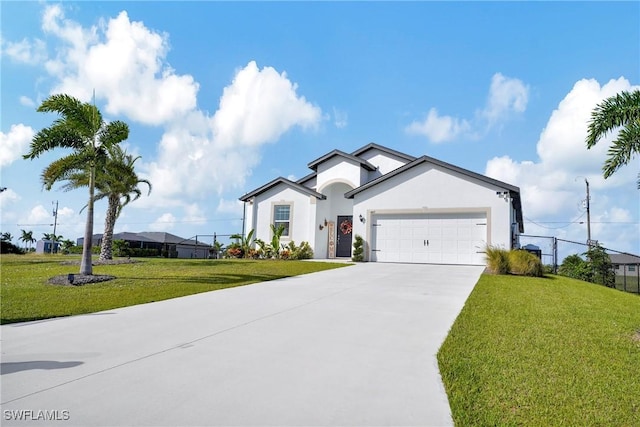 view of front of house with concrete driveway, a front lawn, an attached garage, and stucco siding