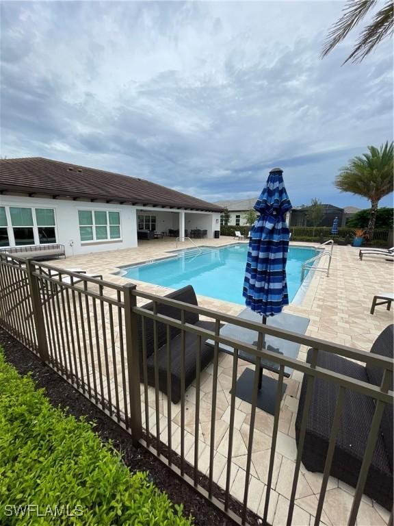 pool featuring a patio area and fence