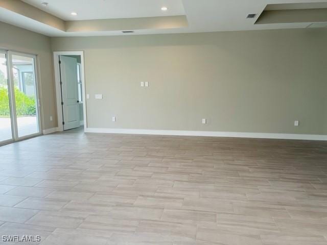3608 Sapphire Cove Cir, Naples, FL 34114 - unfurnished room featuring baseboards, visible vents, and a tray ceiling