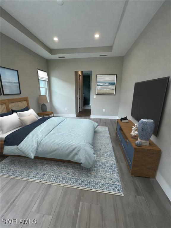 bedroom featuring baseboards, a tray ceiling, wood finished floors, and recessed lighting