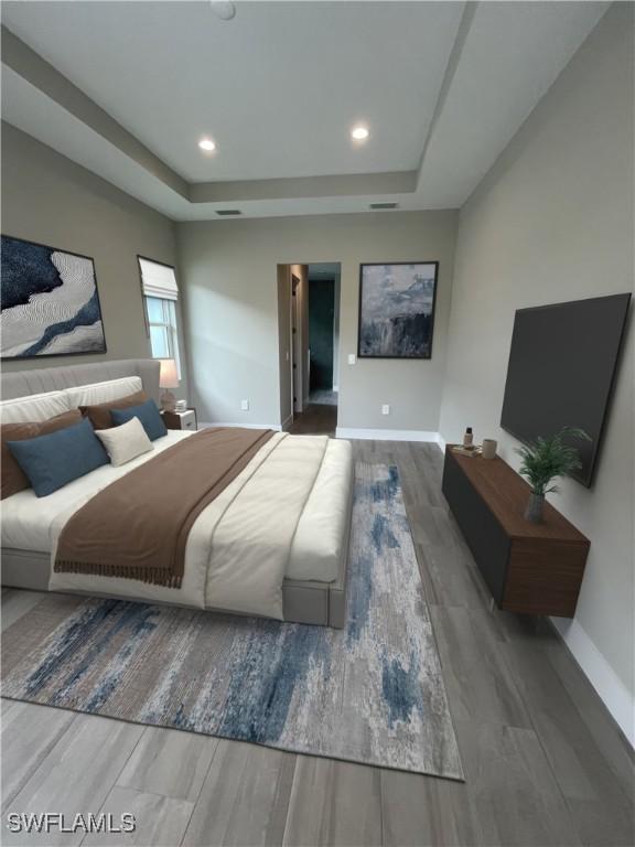 3608 Sapphire Cove Cir, Naples, FL 34114 - bedroom featuring baseboards, recessed lighting, wood finished floors, and a tray ceiling